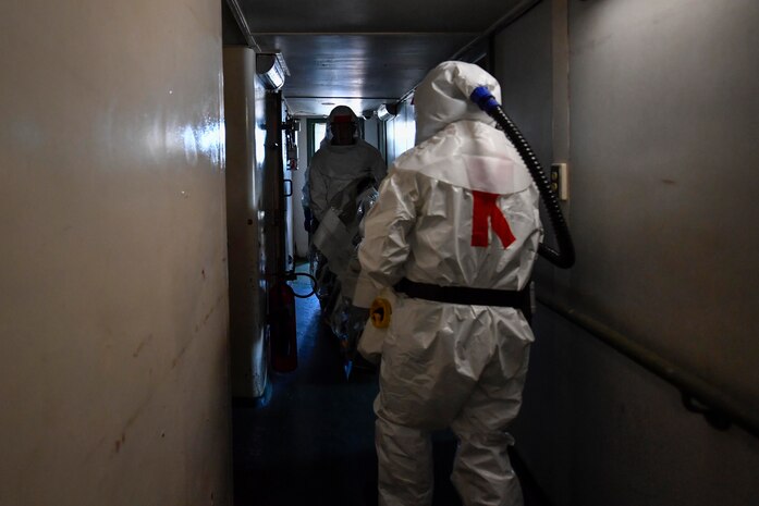 Kurt Jacumin, left, Medical University of South Carolina emergency medical technician, and James Bundo, right, Medical University of South Carolina team leader, carry a stretcher during a communicable disease exercise at the Charleston, S.C. Federal Law Enforcement compound April 4, 2017. The exercise, the first of its kind here, tested communication procedures and the integration of federal, state, local and private industry partners while analyzing response capabilities if an infected person needed to be transported from a vessel to the Port of Charleston. 