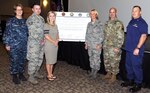 Signing the proclamation marking Sexual Assault Awareness and Prevention Month were (from left) Rear Adm. Rebecca McCormick-Boyle, commander, Navy Medicine Education Training and Logistics Command; Brig. Gen. Heather Pringle, Joint Base San Antonio and 502nd Air Base Wing commander; Brig. Gen. John Hashem, U.S. Army North (Fifth Army) Reserve Affairs deputy commanding general; and Cmdr. Benjamin Golightly, Coast Guard Cryptologic Unit Texas commanding officer. Also in the photo are Staff Sgt. Noah Lubben and his wife Cassie. Lubben, 59th Medical Specialty Squadron cardiopulmonary technician at JBSA-Lackland, spoke at the event about being sexually assaulted while he was on duty in an AC-130 aircraft when he was stationed at Hurlburt Field, Fla., and his decision to report the incident.