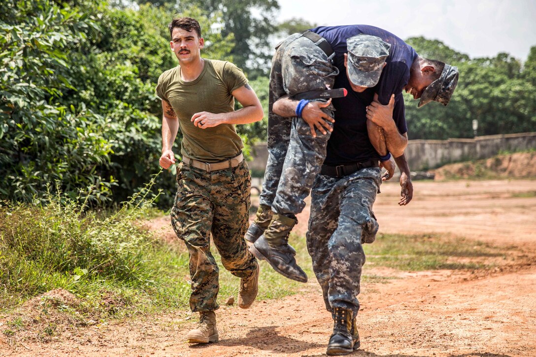 U.S. Navy Petty Officer 3rd Class Ryan Walker, left, runs alongside a Sri Lankan Marine performing a “fireman’s carry” on a mock patient during the tactical casualty combat care portion of a military tactics training and exchange, part of a theater security cooperation engagement at Welissara Naval Base, Sri Lanka, March 29, 2017. Walker is a hospital corpsman assigned to 1st Battalion Landing Team, 4th Marines, 11th Marine Expeditionary Unit. Marine Corps photo by Cpl. Devan K. Gowans