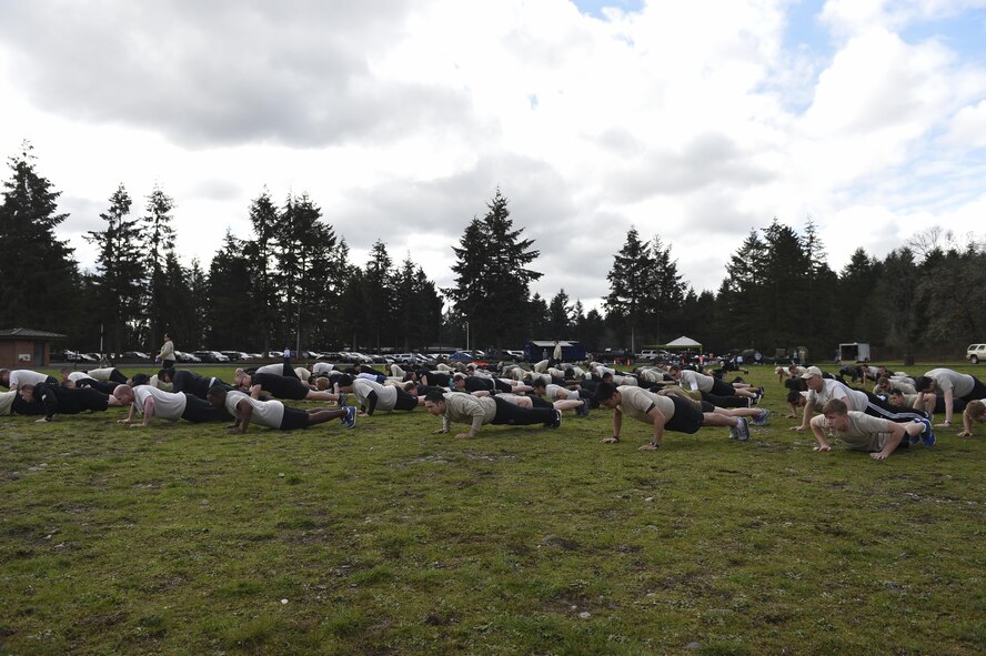 Members of the 1st Air Support Operations Group, 194th ASOG, 62nd Airlift Wing and Joint Base Lewis- McChord, Wash., both military and civilian, perform memorial push-ups after the Tactical Air Control Party 24-hour memorial run at Joint Base Lewis-McChord, Wash., on March 30-31, 2017. The run and push-ups are competed to honor the fallen TACPs and to give back to their families. (Air Force Photo/ Staff Sgt. Naomi Shipley)