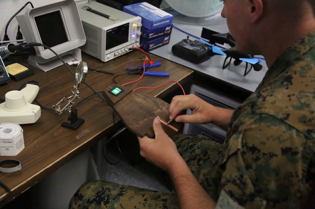 Cpl. Robert Murray, tank commander, Bravo Co., 1st Tank Battalion, tests his fire circuit tester at the Fabrication Laboratory aboard Marine Corps Air Ground Combat Center, Twentynine Palms, Calif., March 29, 2017. The newly established FabLab is the first of its kind in the Marine Corps and will provide Marines and sailors the opportunity to develop avant-garde solutions to common problems through utilizing 3D printing technology. (U.S. Marine Corps photo by Cpl. Medina Ayala-Lo)