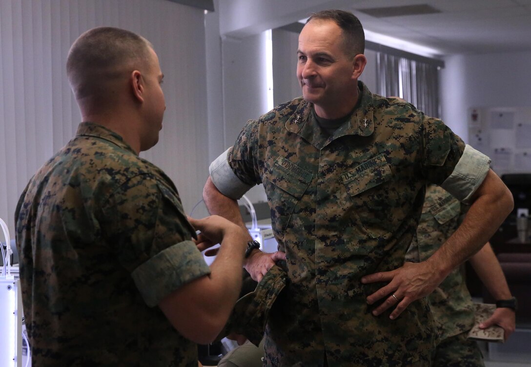 Capt. Zachary Weisenfels, left, officer in charge, Fabrication Laboratory, explains the capabilities of the FabLab to Maj. Gen. Daniel O’Donohue, Commanding General, 1st Marine Division, during a visit to Marine Corps Air Ground Combat Center, Twentynine Palms, Calif., March 29, 2017. The newly established FabLab is the first of its kind in the Marine Corps and will provide Marines and sailors the opportunity to develop avant-garde solutions to common problems through utilizing 3D printing technology. (U.S. Marine Corps photo by Cpl. Medina Ayala-Lo)