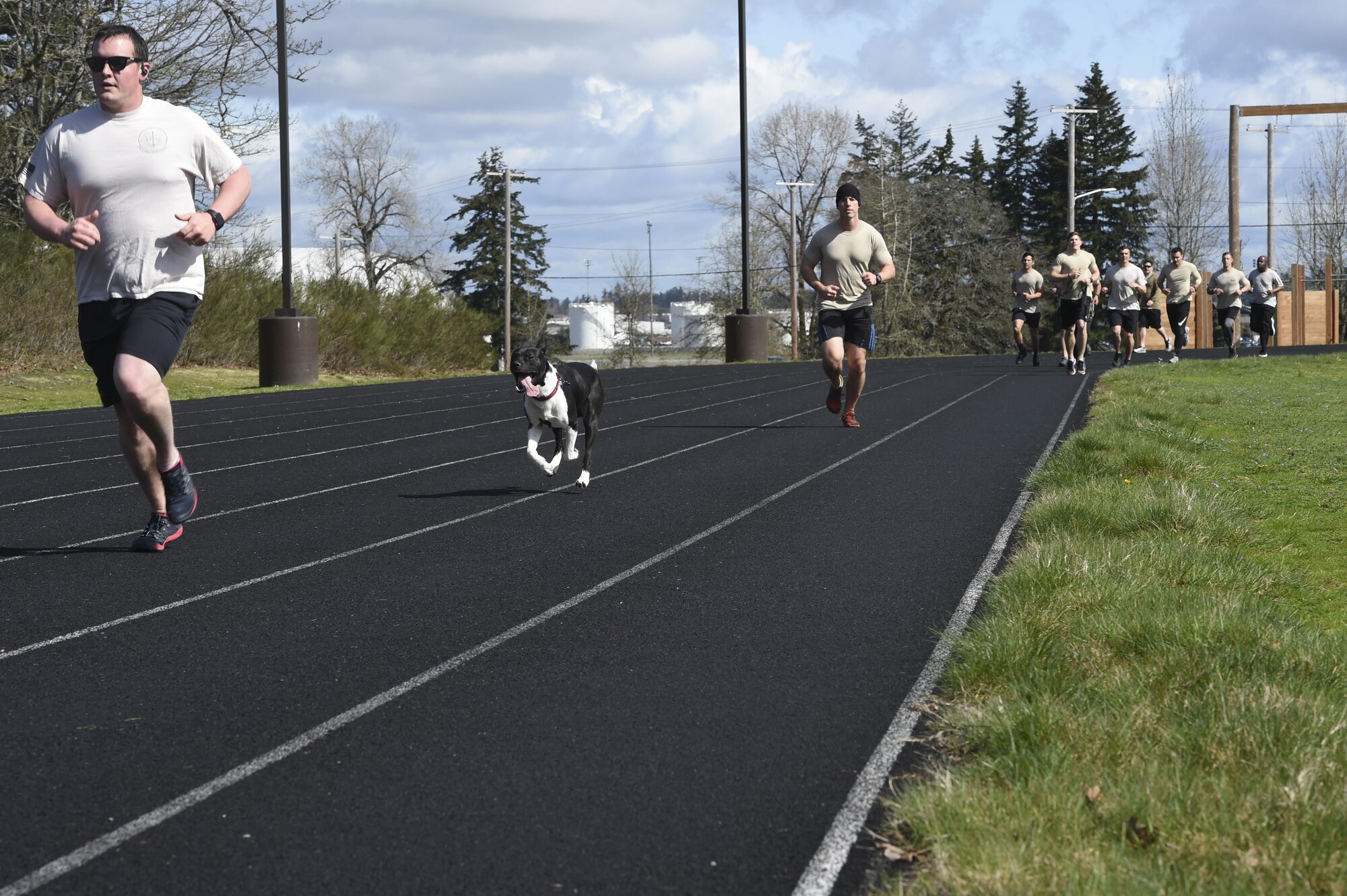 Members and pets of the 1st Air Support Operations Group, 194th ASOG, 62nd Airlift Wing and Joint Base Lewis- McChord, Wash., run and walk on the McChord Field outdoor track, March 31, 2017, to honor TACP Airmen who have died in combat or training  and to raise money and awareness for the Tactical Air Control Party Association. The goal of the annual 24-hour run is to give back to the families and this year the TACP-A collected more than $6,000 in donations. (Air Force Photo/ Staff Sgt. Naomi Shipley)