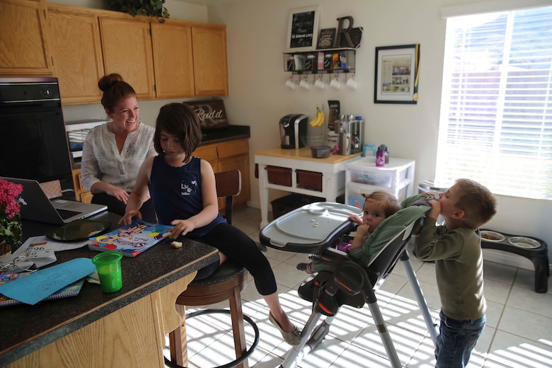 Jessica Rudd, Armed Forces Insurance Marine Spouse of the Year 2017 presented by Military Spouse Magazine, helps her youngest daughter, Molly, 10 months old, stand up at their home in Yucca Valley, Calif., March 29, 2017. Rudd, a Marine veteran, wife and mother of three, was chosen as the 2017 MSOY for her dedication to helping improve the quality of life of military members and their spouses. (U.S. Marine Corps photo by Cpl. Medina Ayala-Lo)