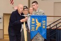 Members of the 307th Bomb Wing alumni groups attached streamers to the 307th Maintenance Squadron&#39;s guidon representing awards received during World War II, the Korean War, Vietnam and the Cold War during the 75th Anniversary Celebration. 