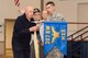 Members of the 307th Bomb Wing alumni groups attached streamers to the 307th Maintenance Squadron's guidon representing awards received during World War II, the Korean War, Vietnam and the Cold War during the 75th Anniversary Celebration. 