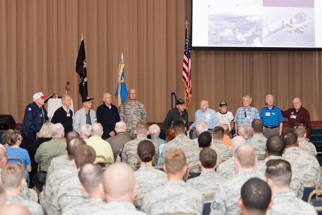 Members of the 307th Bomb Wing alumni groups attached streamers to the 307th Maintenance Squadron's guidon representing awards received during World War II, the Korean War, Vietnam and the Cold War during the 75th Anniversary Celebration. 