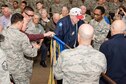 Members of the 307th Bomb Wing alumni groups attached streamers to the 307th Maintenance Squadron&#39;s guidon representing awards received during World War II, the Korean War, Vietnam and the Cold War during the 75th Anniversary Celebration. 