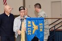 Members of the 307th Bomb Wing alumni groups attached streamers to the 307th Maintenance Squadron&#39;s guidon representing awards received during World War II, the Korean War, Vietnam and the Cold War during the 75th Anniversary Celebration. 
