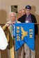 Members of the 307th Bomb Wing alumni groups attached streamers to the 307th Maintenance Squadron&#39;s guidon representing awards received during World War II, the Korean War, Vietnam and the Cold War during the 75th Anniversary Celebration. 