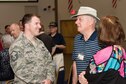 Members of the 307th Bomb Wing alumni groups attached streamers to the 307th Maintenance Squadron&#39;s guidon representing awards received during World War II, the Korean War, Vietnam and the Cold War during the 75th Anniversary Celebration. 