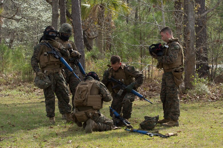 Marines check their gear before practicing room-clearing techniques during a Basic Urban Skills Training course at a Military Operations on Urbanized Terrain event at Camp Lejeune, N.C., April 5, 2017. The Marines participated in the training to learn and reinforce infantry skills as a predeployment work up. The Marines are with 2nd Light Armored Reconnaissance Battalion, Bravo Company, 2nd Marine Division. (U.S. Marine Corps photo by Pfc. Abrey D. Liggins)