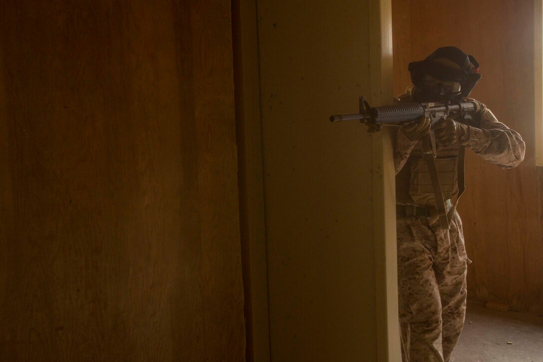 A Marine Division Combat Skills Center instructor, playing the role of an enemy, sights in on trainees during a Basic Urban Skills Training course at a Military Operations on Urbanized Terrain event at Camp Lejeune, N.C., April 5, 2017. The Marines participated in the training to learn and reinforce infantry skills as a predeployment work up. The Marines are with 2nd Light Armored Reconnaissance Battalion, Bravo Company, 2nd Marine Division. (U.S. Marine Corps photo by Pfc. Abrey D. Liggins)