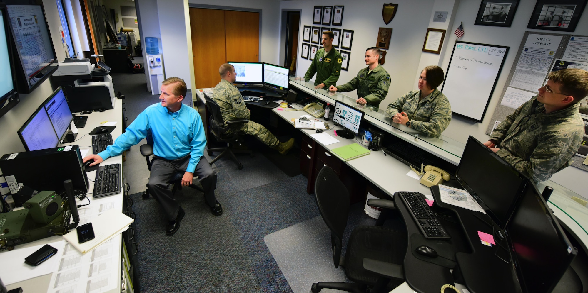 Walter Otto, a meteorological technician assigned to the 509th Operations Support Squadron, relays operational data to an aircrew while flight leadership listens in during a brief at Whiteman Air Force Base, Mo., March 29, 2017. Otto earned the title as Air Force Global Strike Command’s Weather Civilian of the Year for 2016. (U.S. Air Force photo by Airman 1st Class Jazmin Smith)