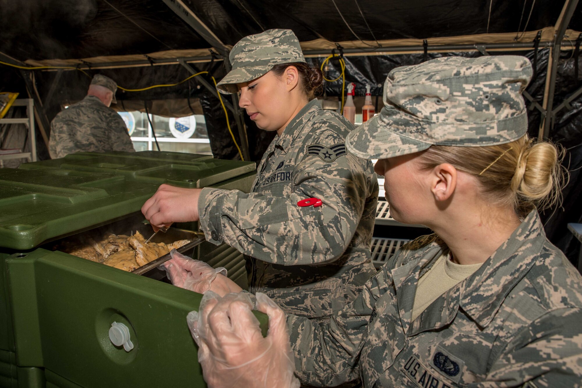 Senior Airman Paige Tranah, and Senior Airman Sarah Overlin, services specialists with the 934th Force Support Squadron working at the Dining Facility at Minneapolis-St. Paul Air Reserve Station, Mn., inspect packaged food items prior to preparing and serving them during the 2017 Hennessy competition. The food items must meet stringent guidelines in order to ensure the food is fresh and the expiration date has not been exceeded. 