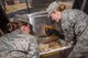 Senior Airman Sarah Overlin and Senior Airman Racheal Semanko, services specialists with the 934th Force Support Squadron working at the Dining Facility at Minneapolis-St. Paul Air Reserve Station, Mn., check the temperature of packaged food items being cooked during the 2017 Hennessy competition. The temperature is closely monitored during the cooking process to ensure food items are thoroughly cooked and safe for consumption. 