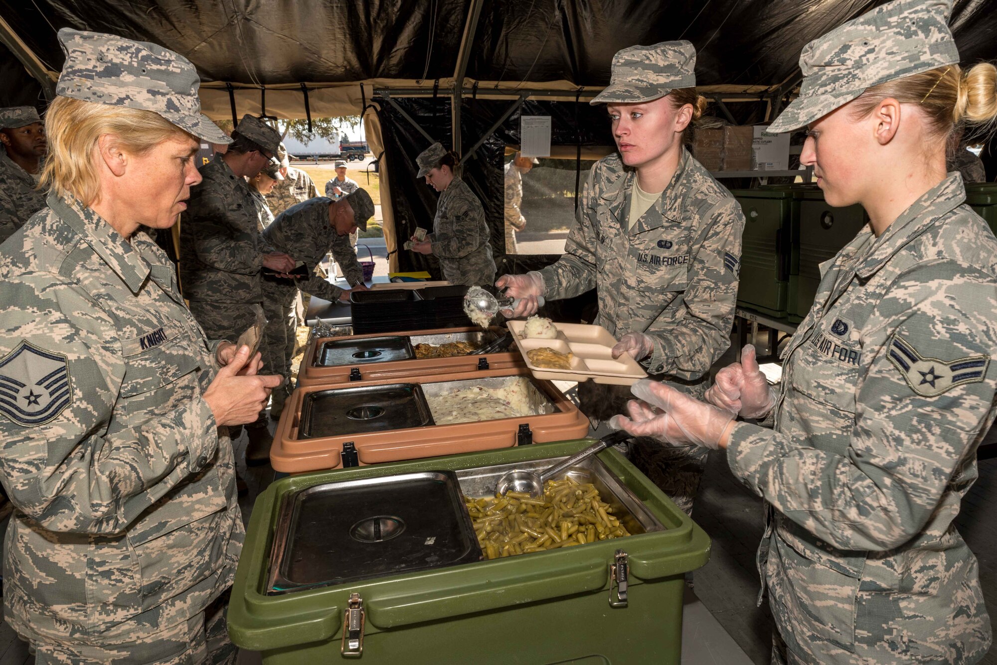 Senior Airman Sarah Overlin and Airman 1st Class Madison Lundborg, services specialists with the 934th Force Support Squadron working at the Dining Facility at Minneapolis-St. Paul Air Reserve Station, Mn., serve Master Sgt. Jody Knight during the 2017 Hennessy competition. The team served more than 288 base personnel which far exceeded any other teams participating in the competition. 