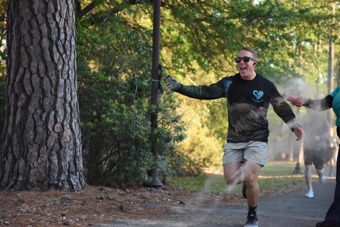 Airman 1st Class Dylan Rumsey, 628th Logistics Readiness Squadron inventory apprentice, runs to the finish line of the Color Run sponsored by Joint Base Charleston Sexual Assault Response and Prevention program at Joint Base Charleston, South Carolina April 7, 2017. The run is part of Sexual Assault Awareness and Prevention Month, an effort to build on existing momentum to eliminate sexual assault.
