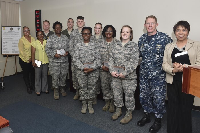 U.S. Navy Capt. Robert Hudson, Joint Base Charleston deputy commander and Naval Support Activity Charleston commander, congratulates SAPR volunteer victim advocates at Joint Base Charleston, South Carolina, April, 5, 2017. Volunteer victim advocates are required to take a 40-hour training certification course. Additionally the volunteers assist the two-person SAPRO team by being on-call to respond immediately to sexual assault victims. 
