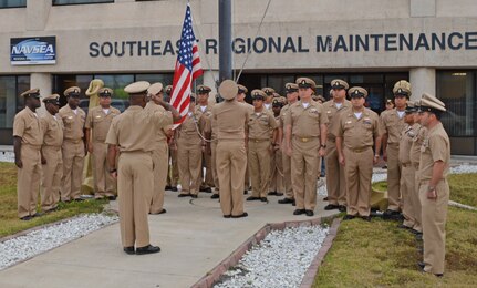 Active and retired Chief Petty Officers (CPO) render morning colors at Southeast Regional Maintenance Center (SERMC) March 31. Raising the colors is part of celebrating the birthday of the Chief, April 1st. The rank of CPO was established by President Benjamin Harrison when he signed General Order 409.

