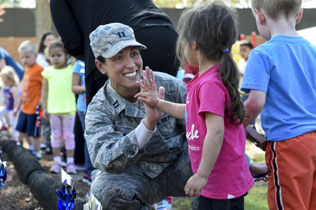 Air Force Capt. Christina A. Stabile participates in a pinwheel parade event with children from the 4th Support Squadron Child Development Center to mark Child Abuse Prevention Month at Seymour Johnson Air Force Base, N.C., April 4, 2017. Stabile is a mental health flight family advocacy officer assigned to the 4th Medical Operations Squadron. Air Force photo by Airman 1st Class Victoria Boyton