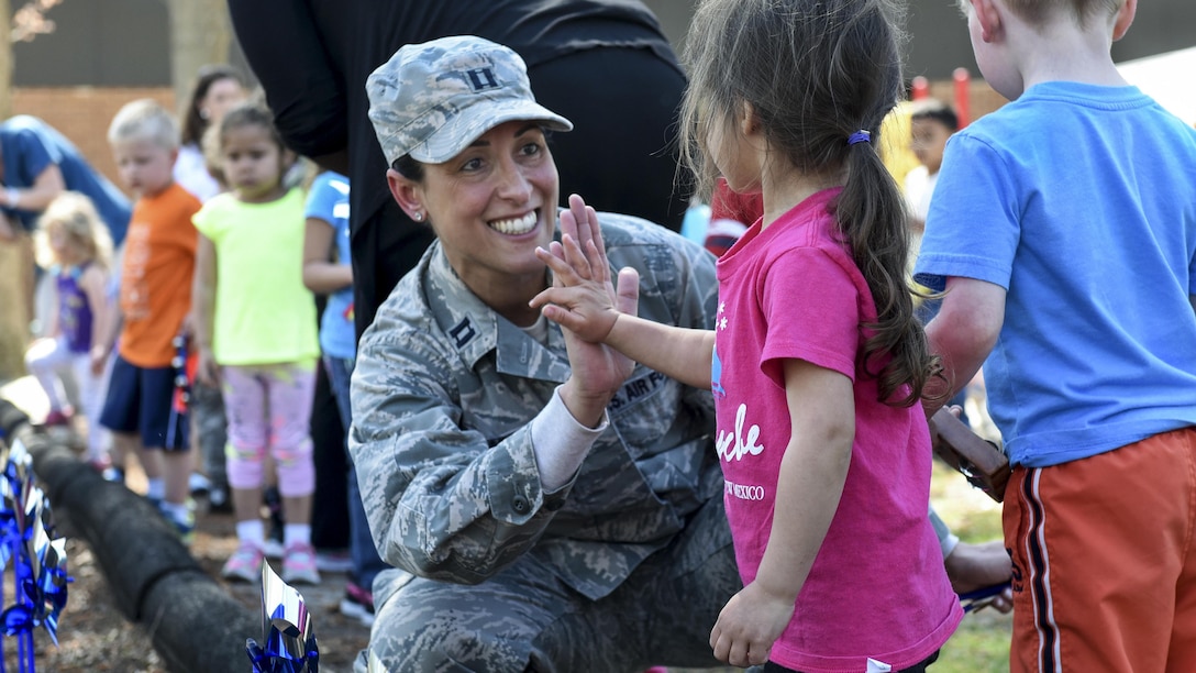 Air Force Capt. Christina A. Stabile participates in a pinwheel parade event with children from the 4th Support Squadron Child Development Center to mark Child Abuse Prevention Month at Seymour Johnson Air Force Base, N.C., April 4, 2017. Stabile is a mental health flight family advocacy officer assigned to the 4th Medical Operations Squadron. Air Force photo by Airman 1st Class Victoria Boyton