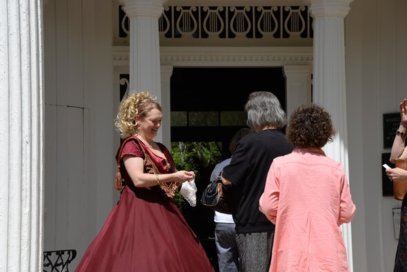 Kristie Hover, spouse of the 14th Flying Training Wing Command Chief, takes tickets from guests touring the Old Waverly Mansion antebellum home April 5, 2017, in West Point, Mississippi. Hover, donning period late 1800's dress,
joins 65 Columbus Air Force Base spouses and family members volunteering for docent duties at local antebellum homes during the 2017 Columbus Spring Pilgrimage. The Pilgrimage began on March 31, and will run through April 8.
