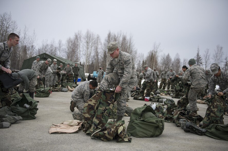 U.S. Air Force Airman Austin Romanov, a 354th Civil Engineer Squadron electrical systems apprentice, puts on his mission-oriented protective posture gear for chemical warfare training during exercise Arctic Gold 17-5 (AG) April 6, 2017, at Spruce Lake on Eielson Air Force Base, Alaska. Airmen from all around the base participated in the chemical warfare training in support of AG 17-5. (U.S. Air Force photo by Airman 1st Class Isaac Johnson)