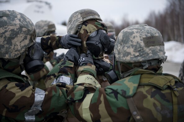 U.S. Air Force Airmen from the 354th Fighter Wing, perform a buddy check on a fellow Airman’s gas mask during chemical warfare training for exercise Arctic Gold 17-5 April 6, 2017, at Spruce Lake on Eielson Air Force Base, Alaska. The Airmen were putting on their gas masks in response to a simulated possible chemical threat. (U.S. Air Force photo by Airman 1st Class Isaac Johnson)