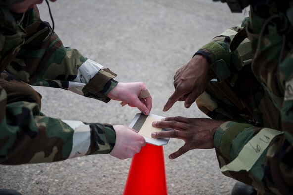 U.S. Air Force Airmen from the 354th Fighter Wing, put down M8 paper during chemical warfare training for exercise Arctic Gold 17-5 April 6, 2017, at Spruce Lake on Eielson Air Force Base, Alaska. M8 paper is a paper used to detect certain types of chemical threats that can be dispersed into the air after a chemical attack. (U.S. Air Force photo by Airman 1st Class Isaac Johnson)