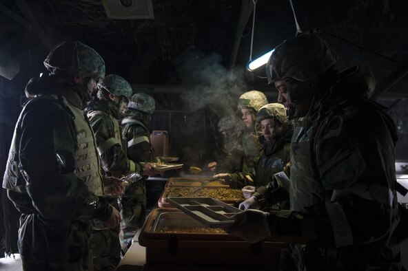 U.S. Air Force Airman Terrance Allen, a 354th Force Support Squadron food service apprentice, serves Airmen during chemical warfare training for exercise Arctic Gold 17-5 April 6, 2017, at Spruce Lake on Eielson Air Force Base, Alaska. During the training, food services members participated in most of the events while also serving hot breakfast and lunch. (U.S. Air Force photo by Airman 1st Class Isaac Johnson)
