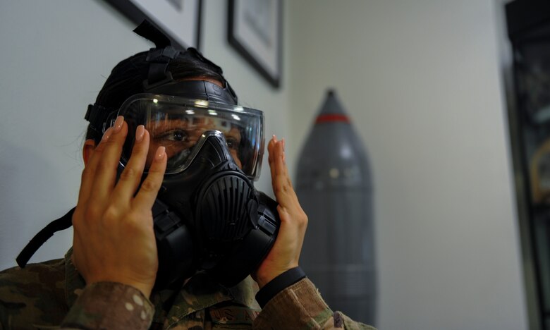 Senior Airman Felicia Arriola an administrative assistant with the 1st Special Operations Maintenance Squadron, tries on a gas mask to ensure it is properly sealed during a chemical, biological, radiological and nuclear survival skills class at Hurlburt Field, Fla., April 4, 2017. The classe teach Air Commandos how to properly inspect, don and wear the Chemical Protective Overgarment in case of a chemical warfare related attack. (U.S. Air Force photo by Airman 1st Class Isaac O. Guest IV)