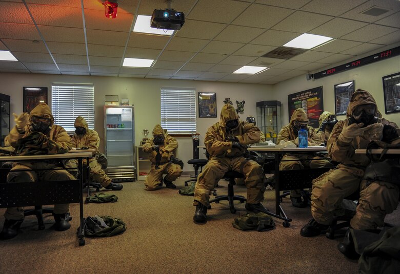 Air Commandos put on the Chemical Protective Overgarment during a chemical, biological, radiological and nuclear defense class at Hurlburt Field, Fla., April 4, 2017. The skills taught during CBRN survival skills prepare Airmen for the possibility of a chemical warfare related attack. (U.S. Air Force photo by Airman 1st Class Isaac O. Guest IV)