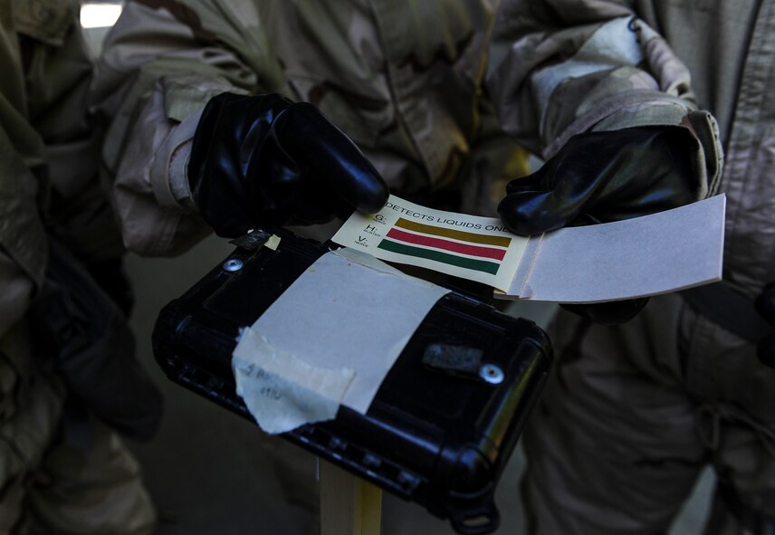 Senior Airman Felicia Arriola, an administrative assistant with the 1st Special Operations Maintenance Squadron, points at M8 paper on a liquid detection point. Hands-on training teaches Air Commandos how to run a PAR Route, or Post Attack Reconnaissance, set up a zone transition point and LDPs. (U.S. Air Force photo by Airman 1st Class Isaac O. Guest IV)