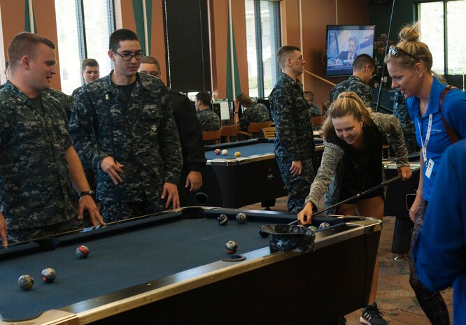 Kayla Day, professional tennis player, plays a game of pool with Naval Nuclear Power Training Unit students April 4, 2017, at the Bowman Center on Joint Base Charleston - Weapons Station, S.C. Day toured the NNPTU campus and signed autographs for Team Charleston members while she was in the Charleston area to compete in the Volvo Car Open tennis tournament.