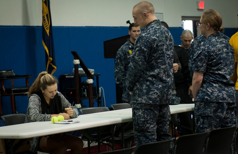 Kayla Day, professional tennis player, autographs tennis balls for Naval Nuclear Power Training Unit students April 4, 2017, at the Bowman Center on Joint Base Charleston - Weapons Station, S.C. Day was a competitor in the Volvo Car Open tennis tournament on Daniel Island, S.C.
