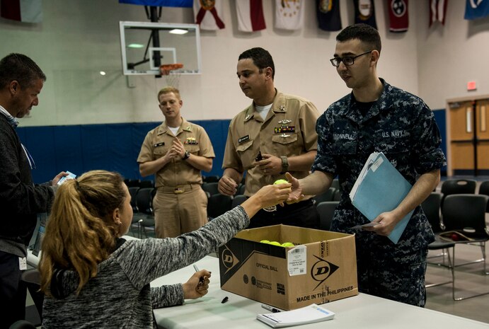 Kayla Day, professional tennis player, hands out autographed tennis balls to Naval Nuclear Power Training Unit students April 4, 2017, at the Bowman Center on Joint Base Charleston - Weapons Station, South Carolina. Day toured the NNPTU campus and signed autographs for Team Charleston members while she was in the Charleston area to compete in the Volvo Car Open tennis tournament.