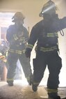 Firefighters assigned to the 22nd Civil Engineer Squadron enter a house during a training exercise April 6, 2017, in base housing at McConnell Air Force Base, Kan. McConnell’s firefighters train regularly to ensure they are prepared to respond to any emergency. (U.S. Air Force photo/Airman 1st Class Erin McClellan)