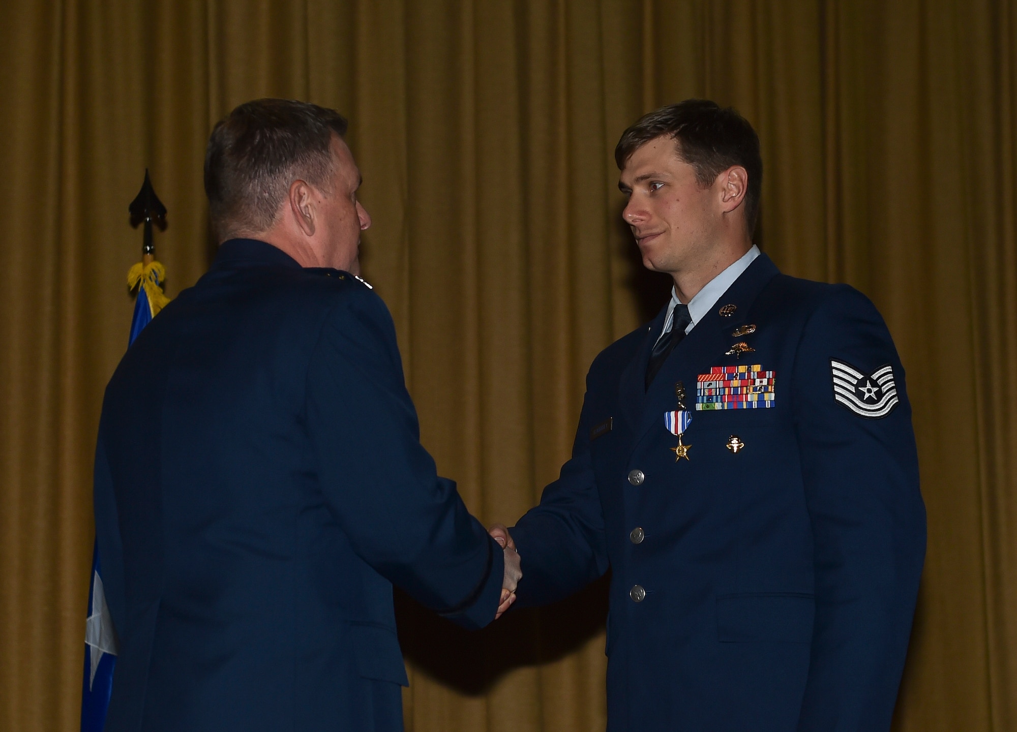 Lt. Gen. Brad Webb, commander of Air Force Special Operations Command, presents Tech. Sgt. Brian Claughsey, a combat controller with the 21st Special Tactics Squadron, a Silver Star Medal April 7, 2017, at Pope Army Airfield, N.C. Following a 96-hour battle with Taliban forces in Afghanistan, Claughsey was credited with coordinating 17 close air engagements, resulting in 47 enemy killed in action without a single civilian or friendly casualty. (U.S. Air Force photo by Senior Airman Ryan Conroy)