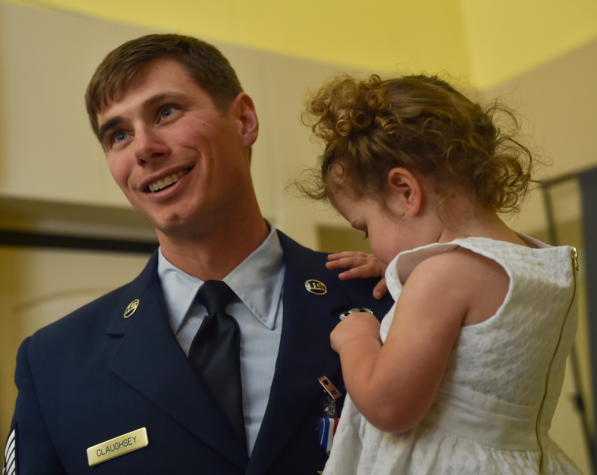 Tech. Sgt. Brian Claughsey, a combat controller with the 21st Special Tactics Squadron, holds his daughter following his Silver Star medal presentation ceremony, April 7, 2017, at Pope Army Airfield, N.C. Claughsey received the Silver Star medal for his role in liberating Kunduz City from Taliban control and ensuring the safety of a 150 joint-coalition team during a 96-hour firefight. (U.S. Air Force photo by Senior Airman Ryan Conroy)