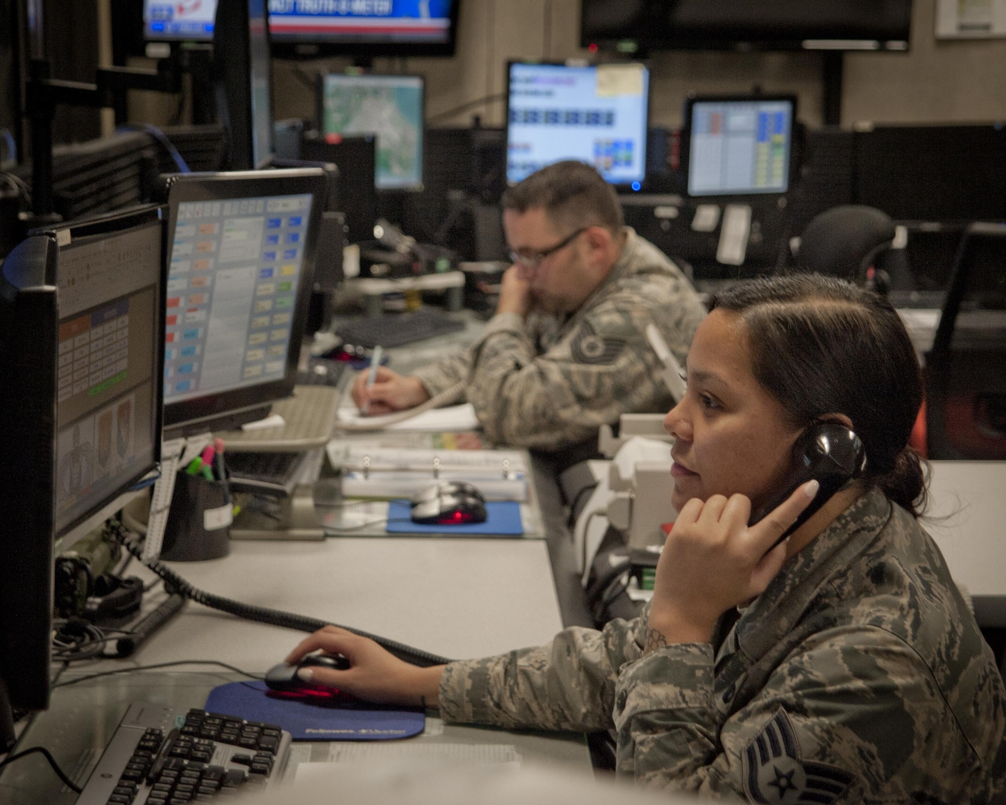U.S. Air Force Tech. Sgt. James Davis, NCO in charge of systems and Staff Sgt. Sheila Cole, command and control procedures instructor, both assigned to the 6th AMW Command Post, answer calls and monitor data at MacDill Air Force Base, Fla., Feb. 16, 2017. The command post is responsible for relaying critical information throughout the base and to military leaders. (U.S. Air Force photo by Airman 1st Class Mariette Adams)