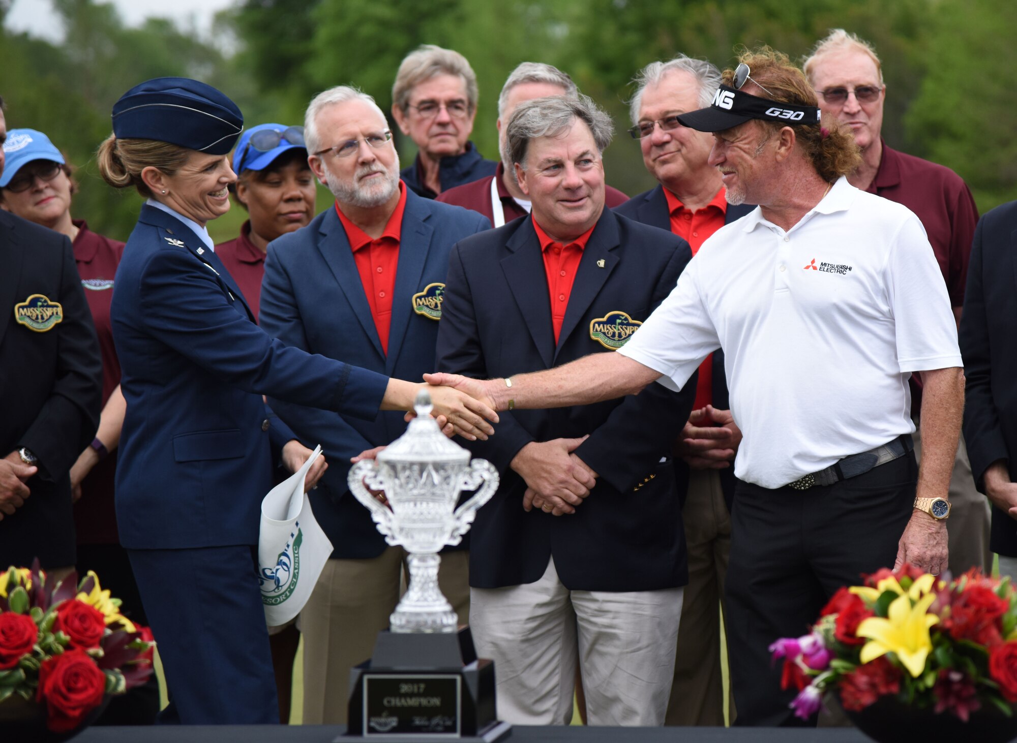 Col. Michele Edmondson, 81st Training Wing commander, congratulates Miguel Jimenez, Professional Golfers’ Association golfer, after winning the Mississippi Gulf Resort Classic at the Fallen Oak Golf Course, April 2, 2017, in Saucier, Miss. Keesler personnel performed the national anthem and presented the colors during the closing ceremony of the three-day event. (U.S. Air Force photo by Kemberly Groue)