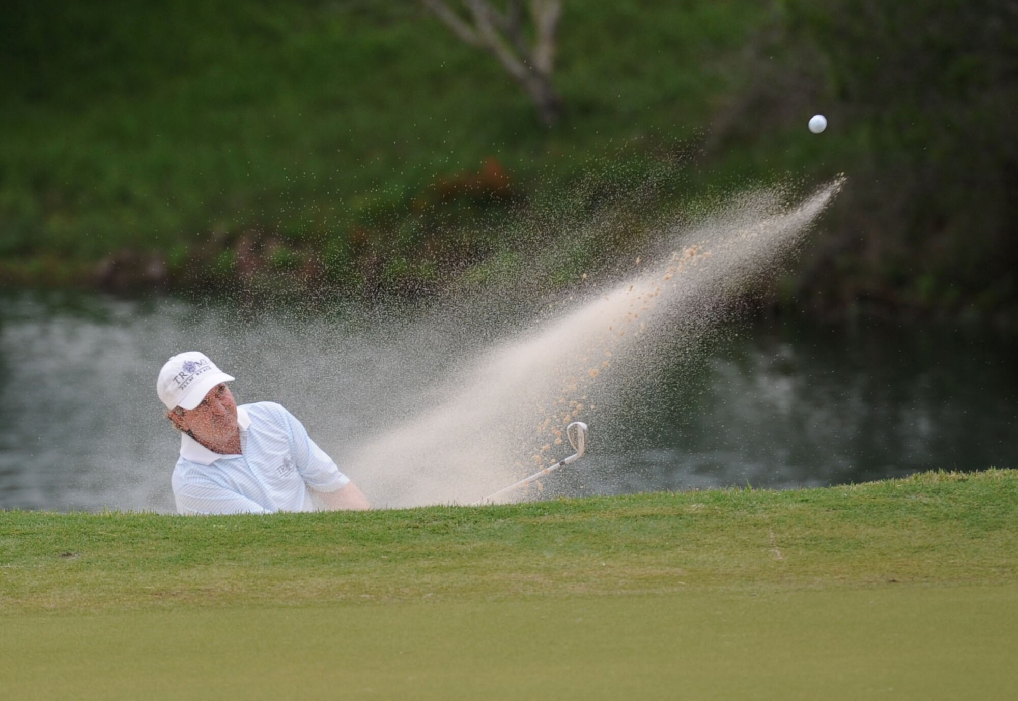 Gene Sauers, Professional Golfers’ Association golfer, hits a golf ball out of a sand pit during the Mississippi Gulf Resort Classic closing ceremonies at the Fallen Oak Golf Course, April 2, 2017, in Saucier, Miss. Col. Michele Edmondson, 81st Training Wing commander, and Keesler personnel participated in the festivities. (U.S. Air Force photo by Kemberly Groue)