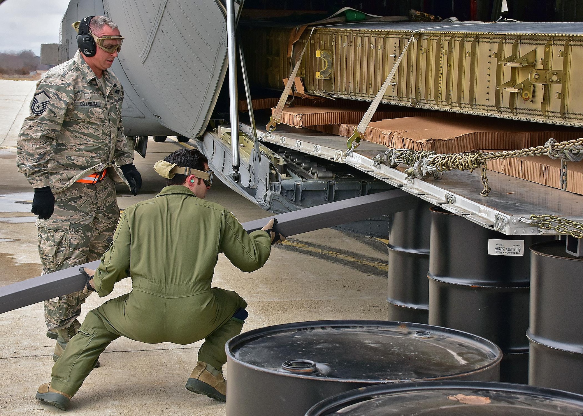 Airmen from the 143d Airlift Wing's Maintenance Group, Operations Group and Logistics Readiness Squadron work together to plan and complete the offload of a detached C-130 wing from the back of a C-130J using the Combat Offload Method B technique. The wing was secured to be used for training by Fuel Cell Airmen, Safety, and Fire personnel.