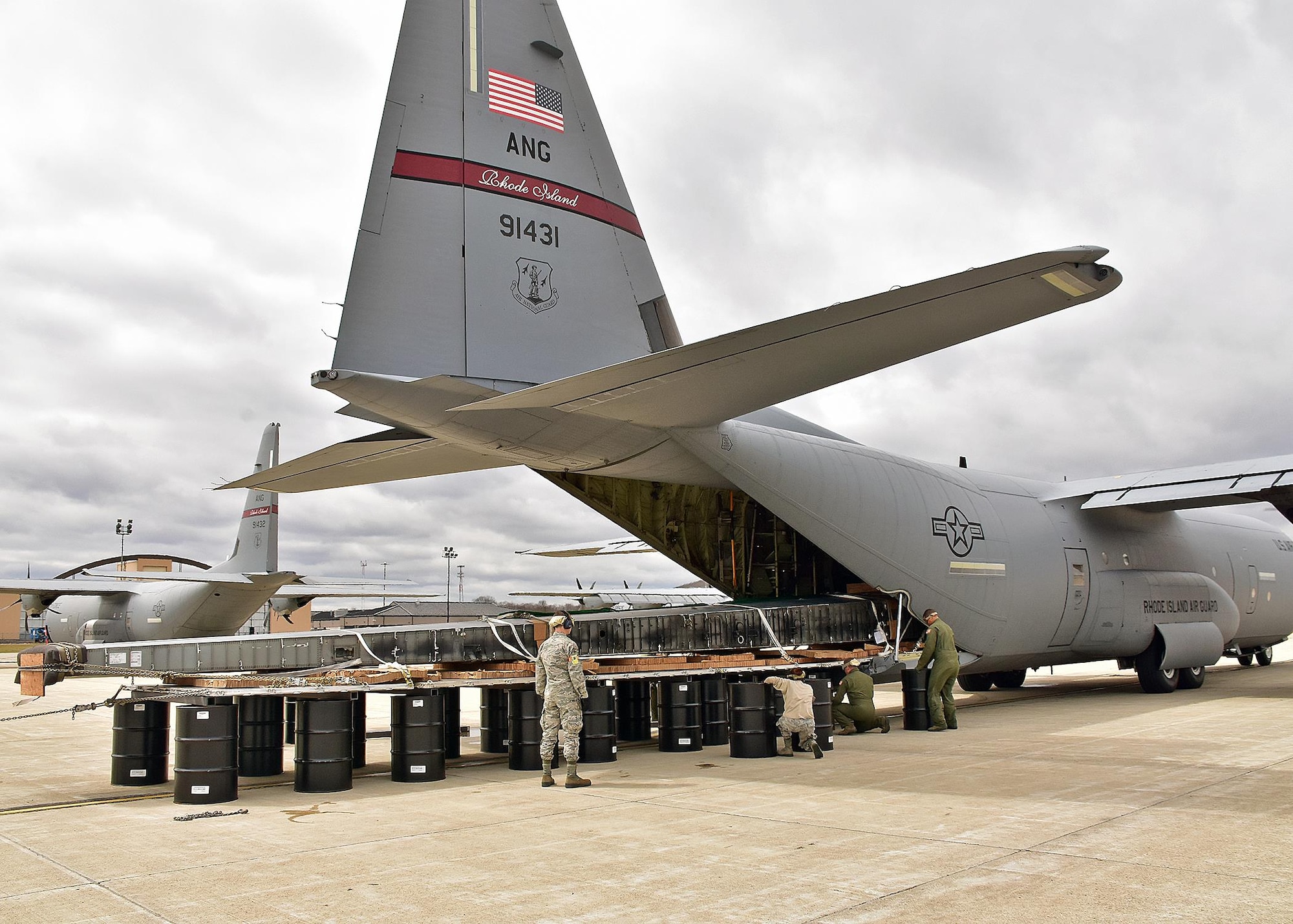 Airmen from the 143d Airlift Wing's Maintenance Group, Operations Group and Logistics Readiness Squadron work together to plan and complete the offload of a detached C-130 wing from the back of a C-130J using the Combat Offload Method B technique. The wing was secured to be used for training by Fuel Cell Airmen, Safety, and Fire personnel.