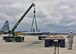 Airmen from the 143d Airlift Wing's Maintenance Group, Operations Group and Logistics Readiness Squadron work together to plan and complete the offload of a detached C-130 wing from the back of a C-130J using the Combat Offload Method B technique. The wing was secured to be used for training by Fuel Cell Airmen, Safety, and Fire personnel.