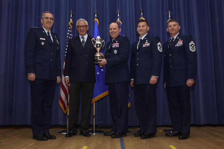 PETERSON AIR FORCE BASE, Colo. –Col. Doug Schiess, 21st Space Wing commander, accepts the Omaha Trophy from Gen. John Hyten, U.S. Strategic Command commander, and Mogens Bay, Strategic Command Consultation Committee, on behalf of the 21st SW during a ceremony in the auditorium on Peterson Air Force Base, Colo., April 6, 2017. This was the first time the 21st SW received the award since its inception in 2008. (U.S. Air Force photo by Airman 1st Class Dennis Hoffman)