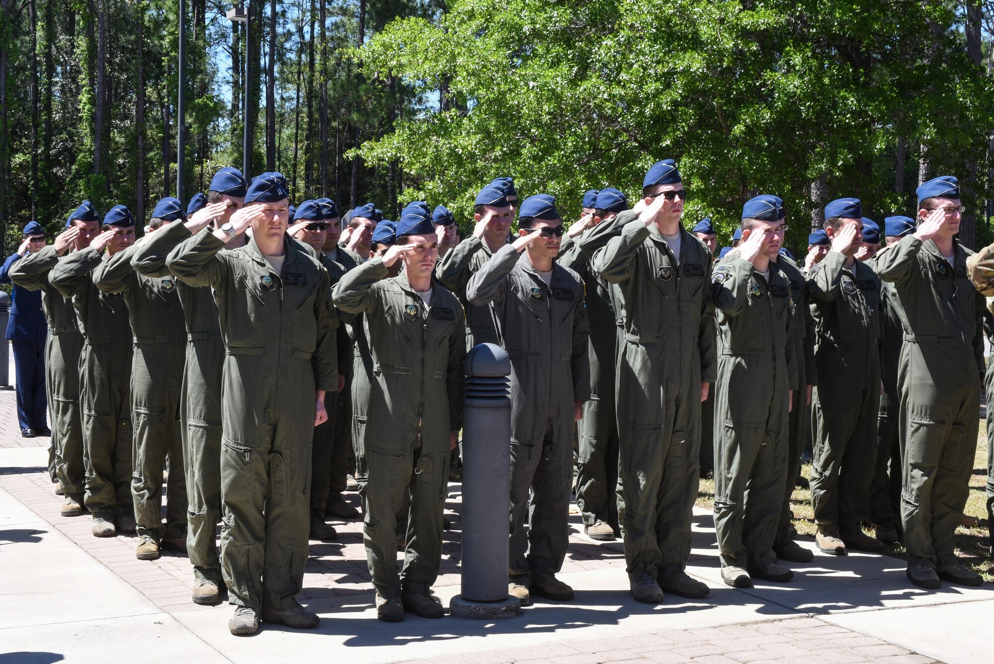 Members of the 319th Special Operations Squadron present arms during the national anthem at the 319th SOS building renaming and dedication ceremony at Hurlburt Field, Fla., April 7, 2017. The 319th SOS building was renamed and dedicated to retired Lt. Col. Richard E. Cole, the last surviving Doolittle Raider and co-pilot to then-Lt. Col. James H. Doolittle. (U.S. Air Force photo by Senior Airman Jeff Parkinson)