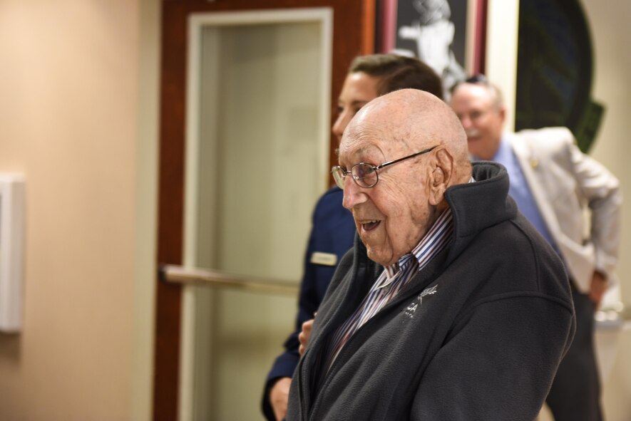 Retired Lt. Col. Richard E. Cole looks at current photos of crew members at the 319th Special Operations Squadron after a building renaming and dedication ceremony at Hurlburt Field, Fla., April 7, 2017. The 319th SOS building was renamed and dedicated to retired Lt. Col. Richard E. Cole, the last surviving Doolittle Raider and co-pilot to then-Lt. Col. James H. Doolittle. (U.S. Air Force photo by Senior Airman Jeff Parkinson)