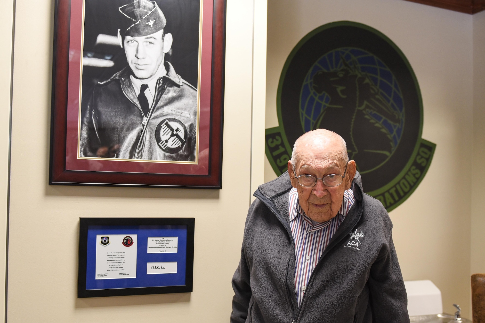Retired Lt. Col. Richard E. Cole stands with a portrait of himself from his time in the Army Air Corps during World War II at the 319th Special Operations Squadron, Hurlburt Field Fla., April 7, 2017. In early 1942, Cole volunteered for Special Mission Number 1, which trained at Eglin Air Field, and on April 18, 1942, he served as then-Lt. Col. James H. Doolittle’s co-pilot during the Raid on Tokyo. (U.S. Air Force photo by Senior Airman Jeff Parkinson)